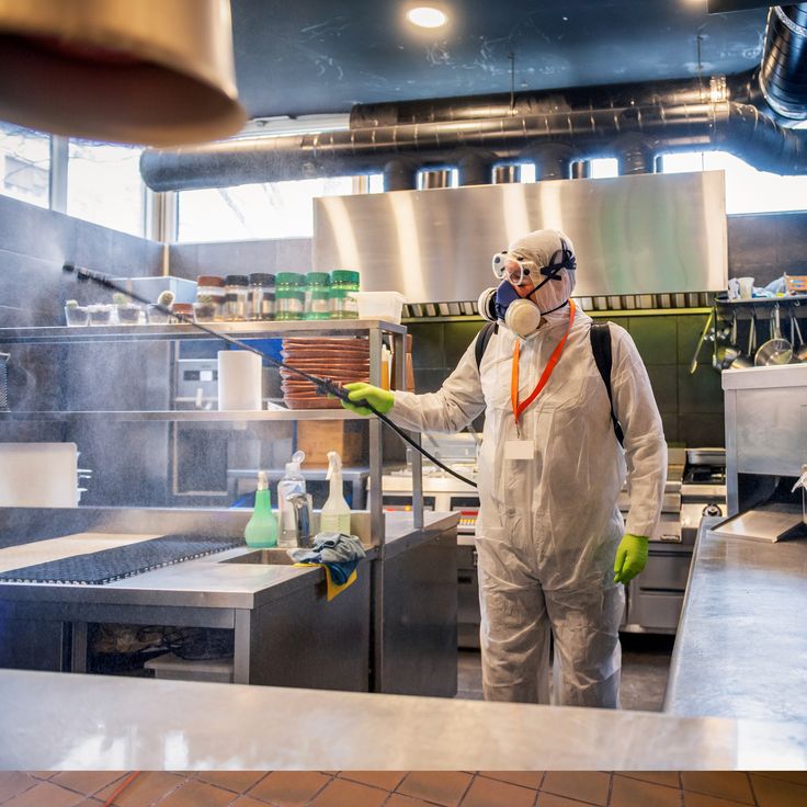 PPE-clad team performing deep cleaning in a restaurant