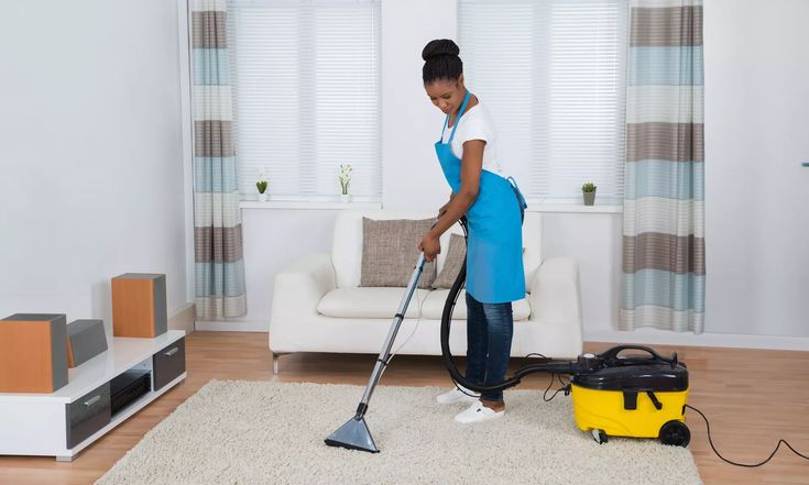 Professional housemaid vacuuming a living room in Qatar